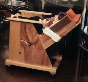 Photo: a wooden “wheelchair” at Hopkins created by therapist-carpenter collaboration